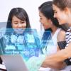 Three persons looking at a Laptop with visuals 